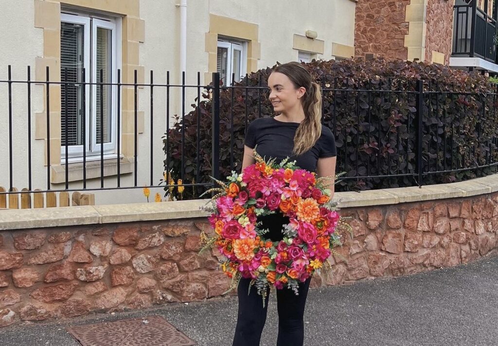 A festive twist in Somerset: Hannah Cape dazzles neighbors with her disco-ball-themed Christmas door, reusing decorations for a sustainable and glittering display.