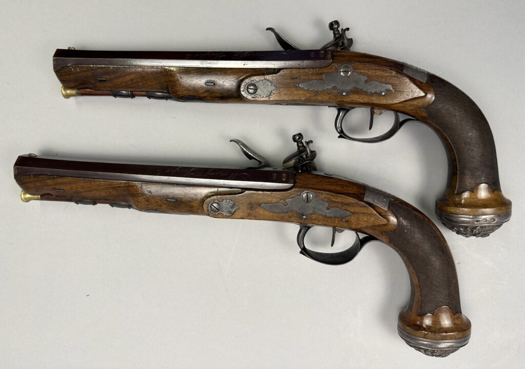 A pair of pistols gifted by Napoleon to a Royal Navy officer after Waterloo sold for £37,500 at Olympia Auctions, marking a historic moment in British and French history.