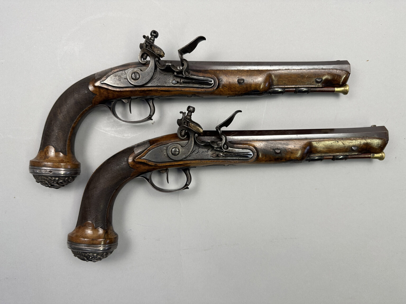 A pair of pistols gifted by Napoleon to a Royal Navy officer after Waterloo sold for £37,500 at Olympia Auctions, marking a historic moment in British and French history.