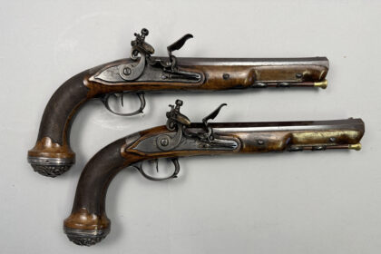 A pair of pistols gifted by Napoleon to a Royal Navy officer after Waterloo sold for £37,500 at Olympia Auctions, marking a historic moment in British and French history.