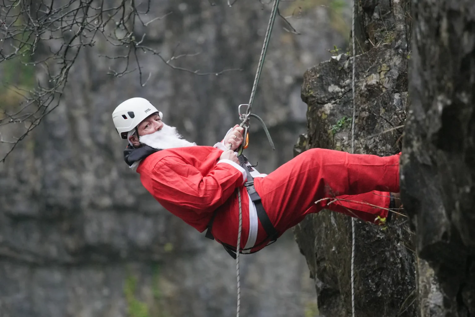 OAP, 82, abseils down iconic 60ft ravine dressed as Father Christmas