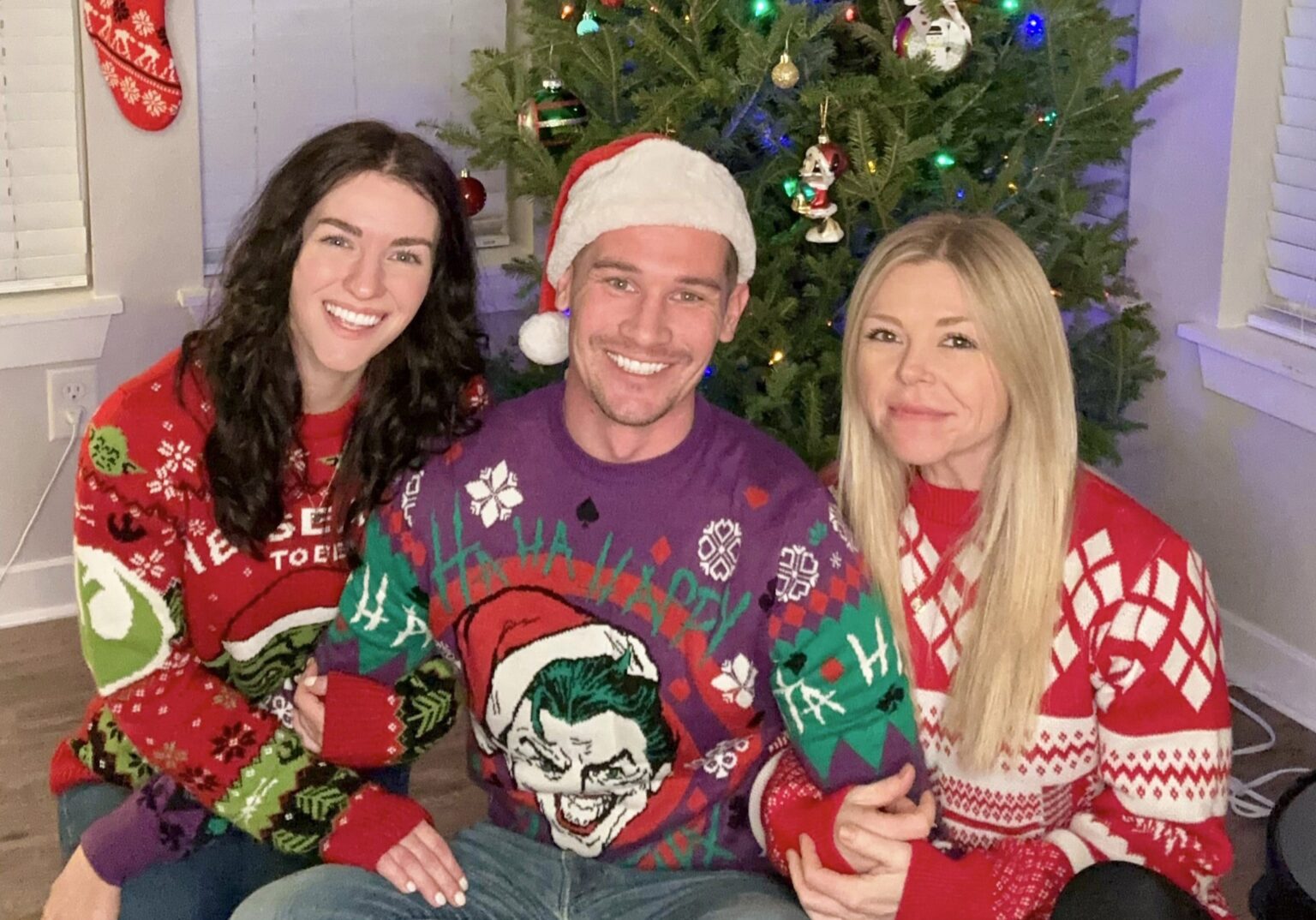 A Colorado throuple shares their Christmas traditions, from matching onesies to festive meals, aiming to normalize their unique love amid judgment and online trolls.