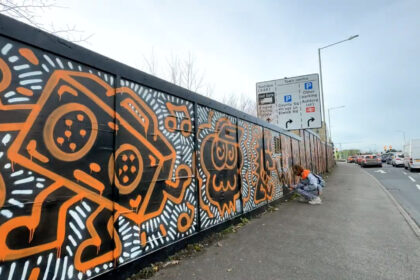 Graffiti artist Mr Doodle creates a stunning 660ft mural in Ashford, Kent, transforming hoardings with his signature style in just one day, sparking local excitement and selfies.