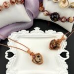 A Canadian jeweler has carved out a unique niche, creating custom pieces using materials like human bones, semen, umbilical cords, and breastmilk. Her daring work often goes viral!