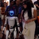 Actress Ingrid Ohara stuns Rio shoppers with robot helpers carrying luxury bags. Futuristic scenes spark awe and confusion, going viral online with global buzz!