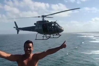 Helicopter pilot's kind gesture goes viral as he pauses mid-flight for a tourist's selfie, creating an unforgettable moment over Itapirubá Beach in Brazil.