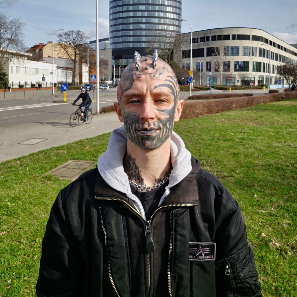 A body modification enthusiast, transforming into a ‘reptilian,’ gets silicone implants in his skull to achieve a cohesive lizard-inspired look, sparking mixed reactions.