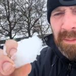 Britain's biggest snowball fight postponed due to icy, rock-hard snow raising safety concerns, but organizers remain hopeful for a rescheduled event with better conditions.