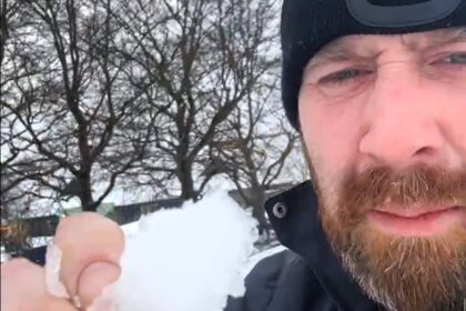 Britain's biggest snowball fight postponed due to icy, rock-hard snow raising safety concerns, but organizers remain hopeful for a rescheduled event with better conditions.