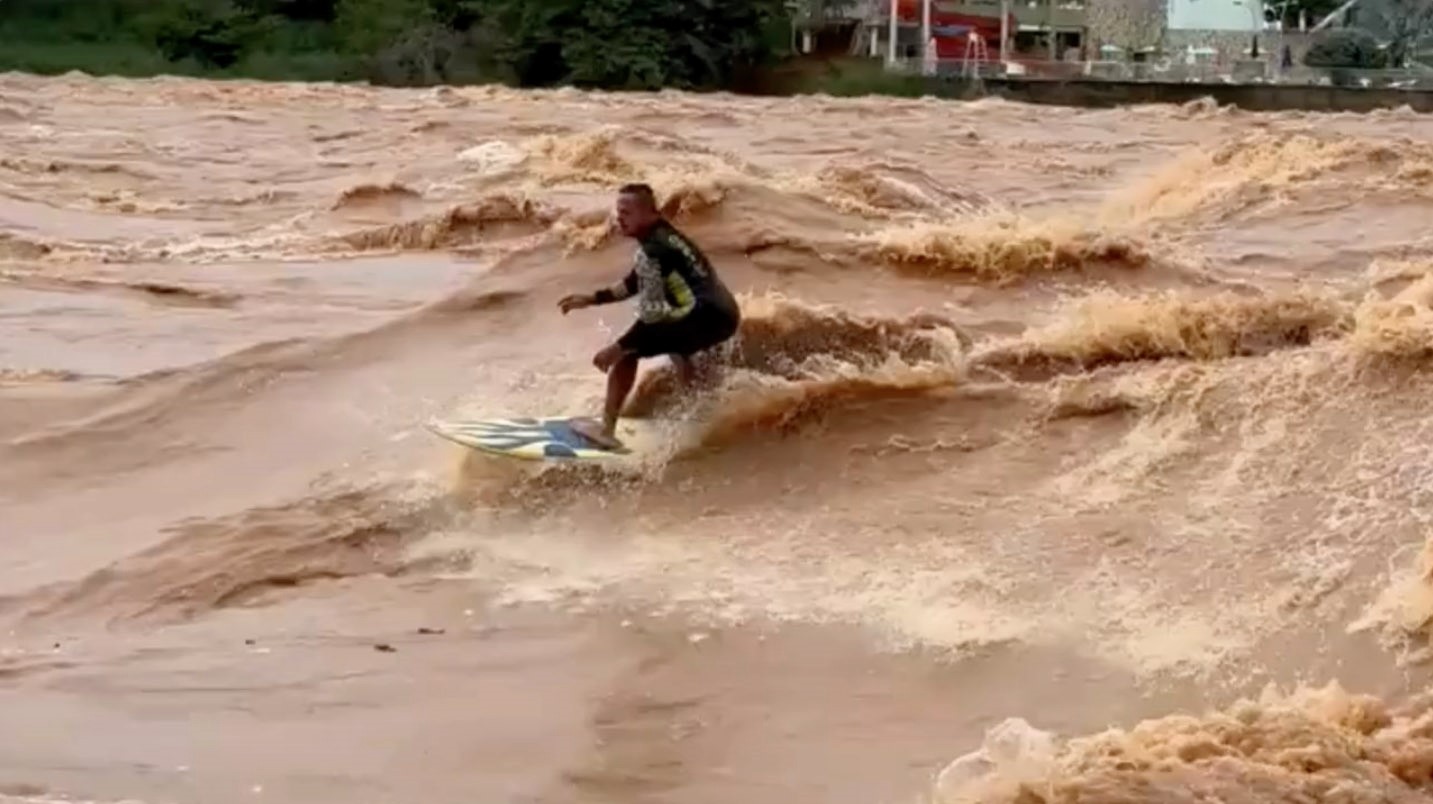 A daring surfer rode the swollen, rapid-moving Doce River in Brazil after heavy rains. Despite warnings from authorities about extreme dangers, Paulo Guido Coelho embraced the challenge.