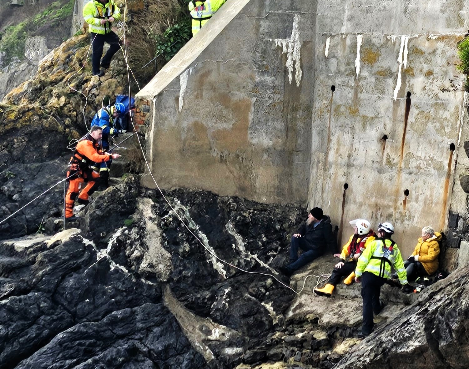 A couple and their dog were rescued in Tenby after being trapped by an incoming tide. Lifeboat, coastguard, and helicopter teams ensured their safe escape.