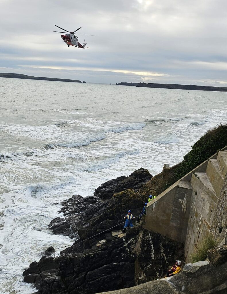 A couple and their dog were rescued in Tenby after being trapped by an incoming tide. Lifeboat, coastguard, and helicopter teams ensured their safe escape.