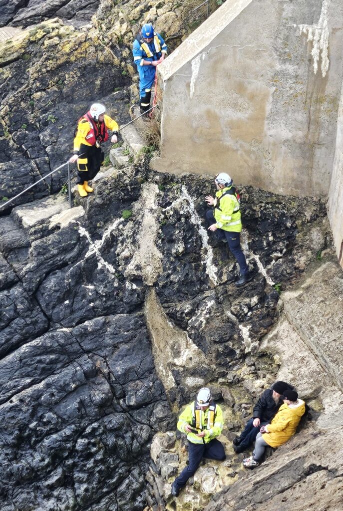 A couple and their dog were rescued in Tenby after being trapped by an incoming tide. Lifeboat, coastguard, and helicopter teams ensured their safe escape.