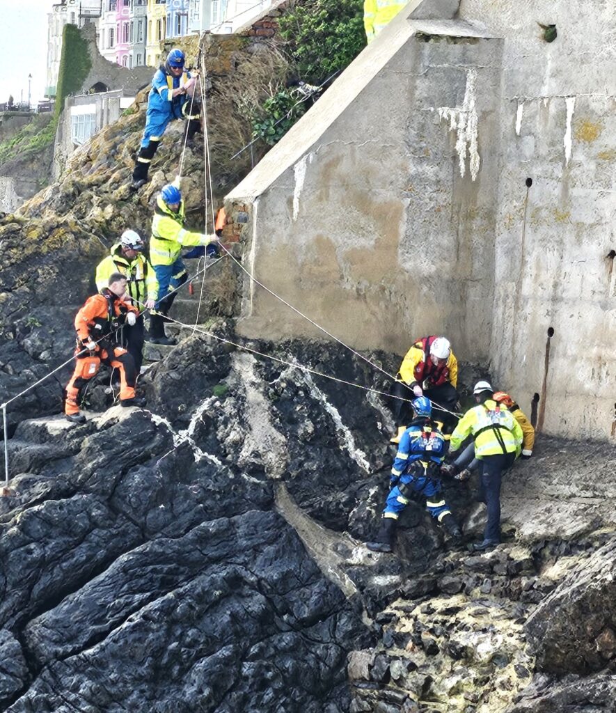 A couple and their dog were rescued in Tenby after being trapped by an incoming tide. Lifeboat, coastguard, and helicopter teams ensured their safe escape.