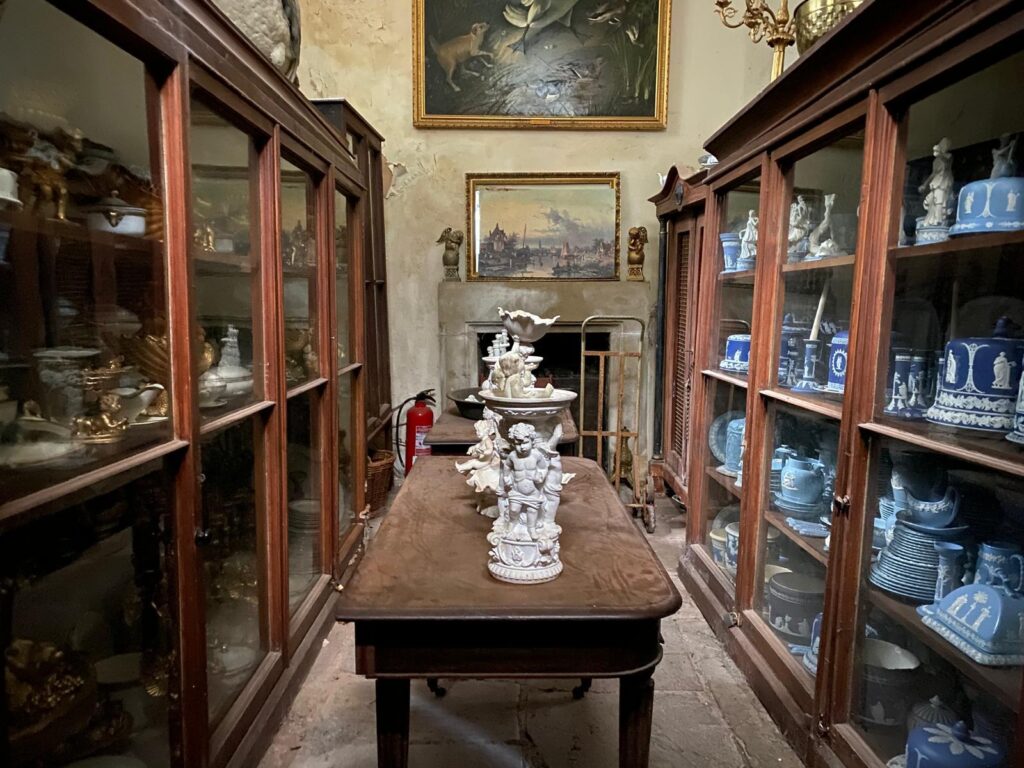 Hundreds of antiques from haunted Jacobean mansion Plas Teg, including rare ceramics, paintings, and Victorian furnishings, are up for auction to cover the owner's care costs.