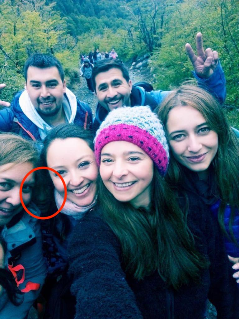 A hiking group selfie goes viral as viewers spot a mysterious face lurking between friends. Is it a ghost, prank, or pareidolia? Discover the chilling viral photo!