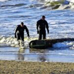 WWII torpedo remnant discovered on a Dutch beach, prompting a beach closure. Defense teams confirmed no explosives, and the artifact was safely removed by experts.