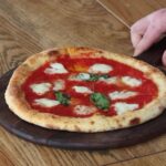 Gordon Ramsay faces backlash over his £13.50 margherita pizza, criticized by fans for its lack of cheese and 'floppy' structure, sparking debate online about its quality.