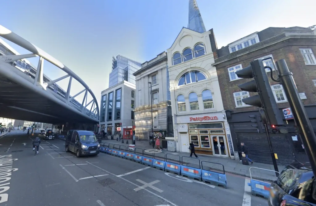 A London bus driver smashed a window after misjudging a turn near The Shard, sparking debate over blame. Locals criticized bystanders for filming instead of helping.