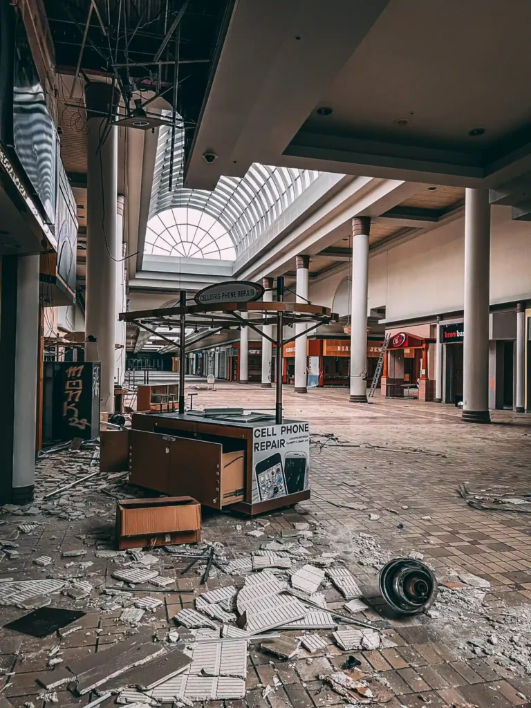 Explore the eerie remains of an abandoned Ohio mall, frozen in time with flooded floors, graffiti, and retro posters, sparking comparisons to The Last of Us.