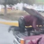 A mechanic was spotted fixing an engine on a moving truck in Mexico, with the driver peering past the raised bonnet. The shocking motorway stunt left locals outraged.