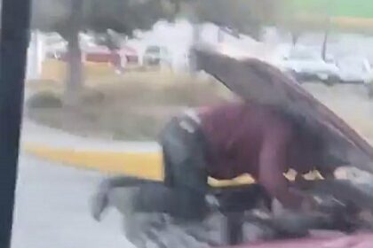 A mechanic was spotted fixing an engine on a moving truck in Mexico, with the driver peering past the raised bonnet. The shocking motorway stunt left locals outraged.