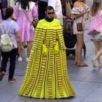 Man in a Scotch-brite sponge dress and woman with a Post-it note bag turn heads in Singapore, part of Lazada's bold campaign redefining fashion as everyday essentials.