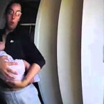 Mum left in stitches after her baby poos on her arm during doorstep chat with charity worker, a hilarious moment caught on CCTV and shared with her husband.