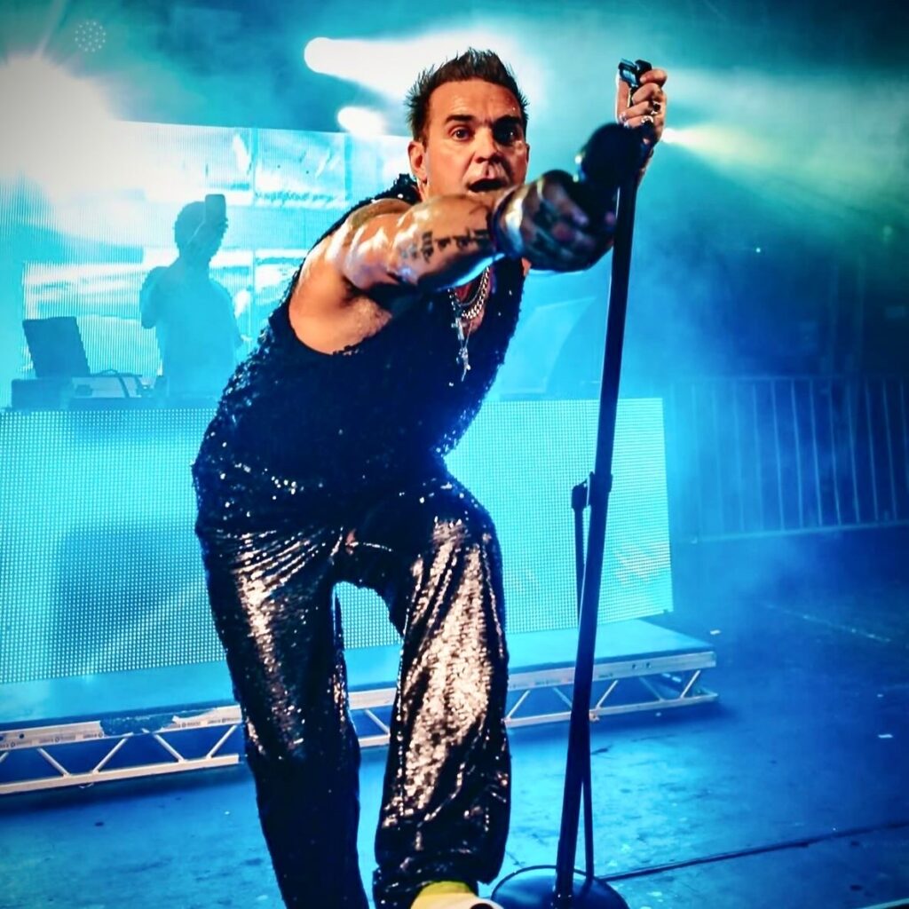 Robbie Williams impersonator Tony Lewis is booked until 2026 after the pop star's biopic "Better Man" hit cinemas, sparking global demand for his tribute performances.