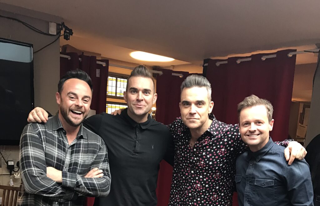 Robbie Williams impersonator Tony Lewis is booked until 2026 after the pop star's biopic "Better Man" hit cinemas, sparking global demand for his tribute performances.