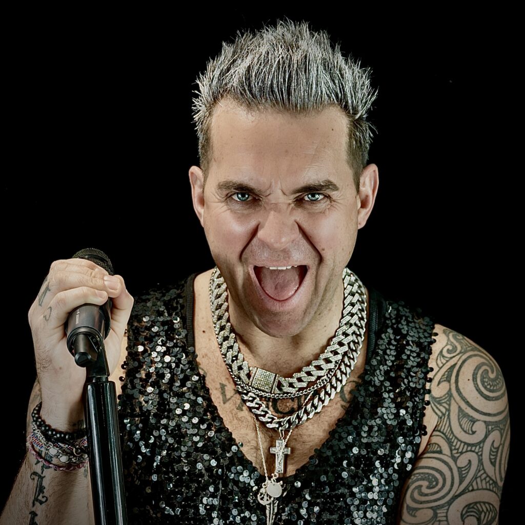 Robbie Williams impersonator Tony Lewis is booked until 2026 after the pop star's biopic "Better Man" hit cinemas, sparking global demand for his tribute performances.