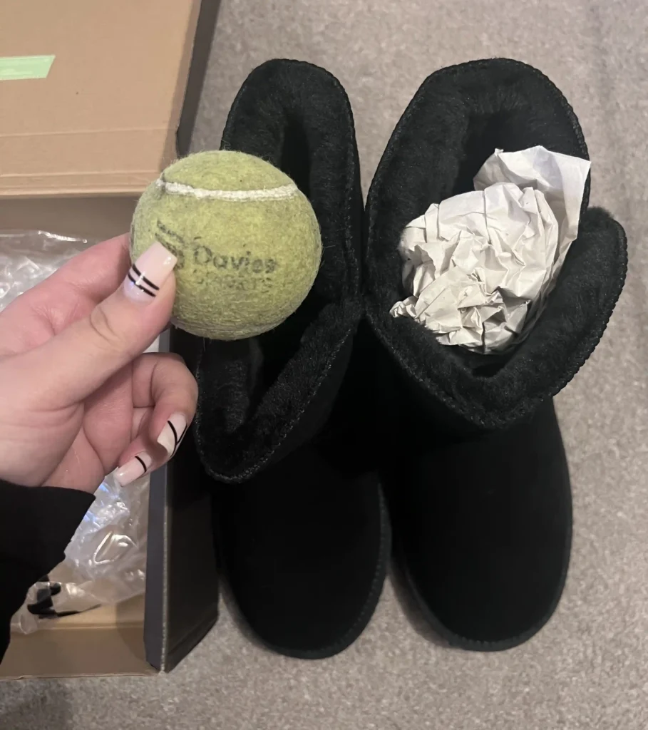 A shopper was shocked to find a dirty tennis ball inside her new £59.90 boots from Amazon. While puzzled, she joked about the unexpected "equipment upgrade."