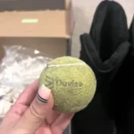 A shopper was shocked to find a dirty tennis ball inside her new £59.90 boots from Amazon. While puzzled, she joked about the unexpected "equipment upgrade."