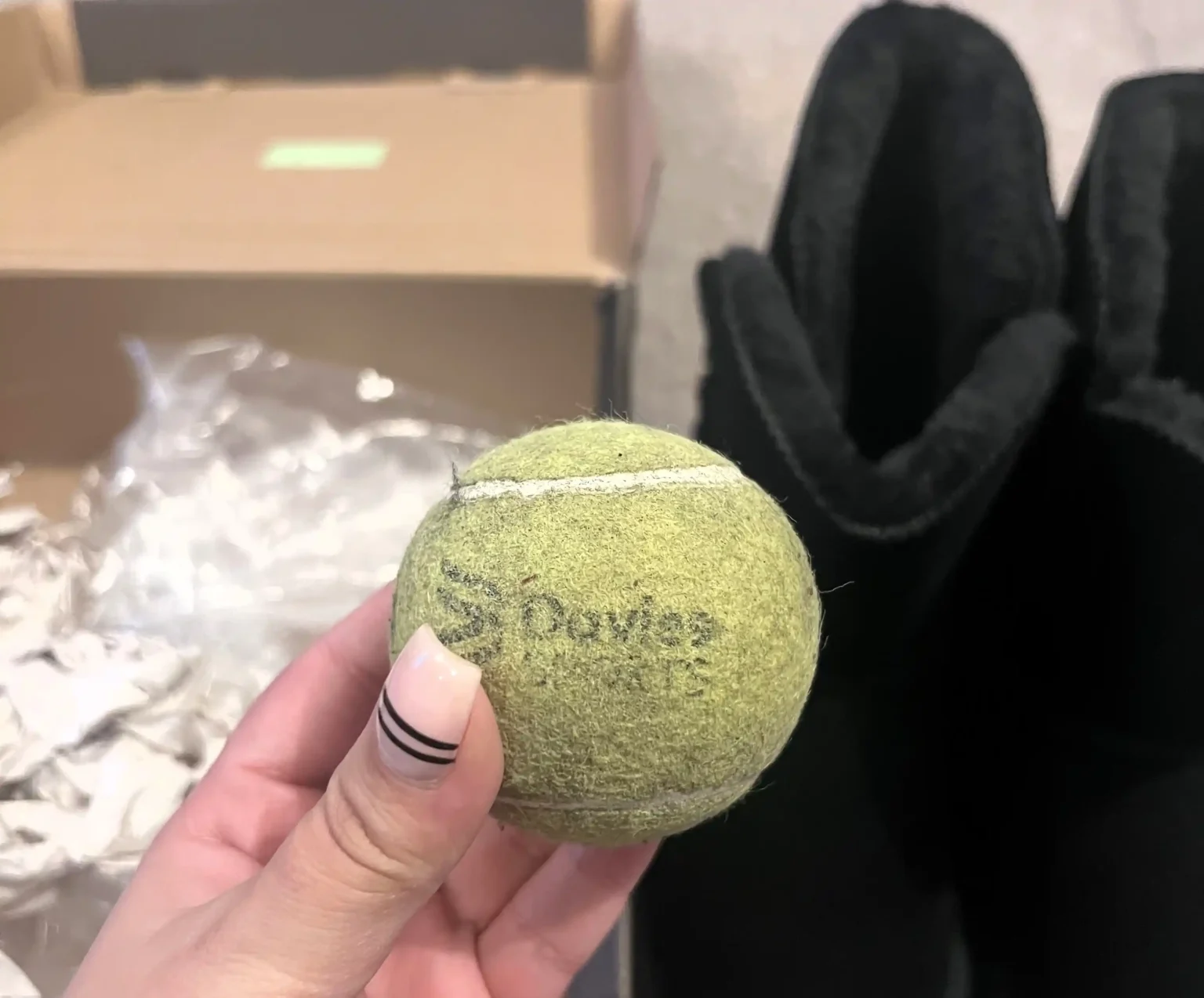 A shopper was shocked to find a dirty tennis ball inside her new £59.90 boots from Amazon. While puzzled, she joked about the unexpected "equipment upgrade."