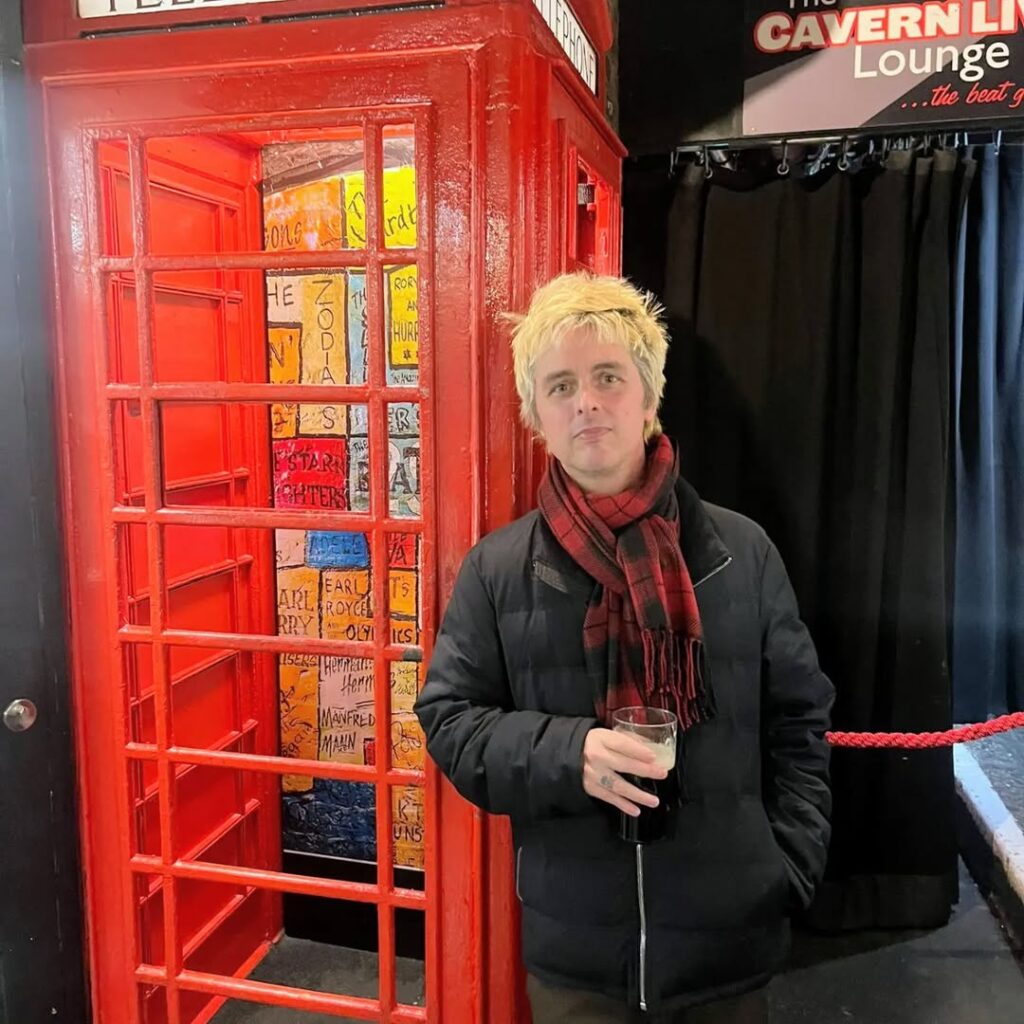 Singer stunned as Green Day’s Billie Joe Armstrong surprises him at Liverpool’s Cavern Club, clapping and filming as he performs Green Day’s iconic *Good Riddance*.