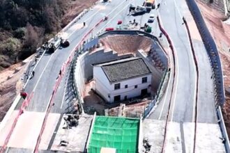 "Strongest nail house" owner regrets defying Chinese authorities after motorway is built around his home, leaving him isolated and facing an uncertain future.