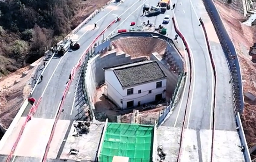 "Strongest nail house" owner regrets defying Chinese authorities after motorway is built around his home, leaving him isolated and facing an uncertain future.