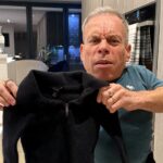 Warwick Davis humorously called out Reiss after his wool jumper shrank in the wash, joking it now fits an Action Man. Fans shared laughs and advice.