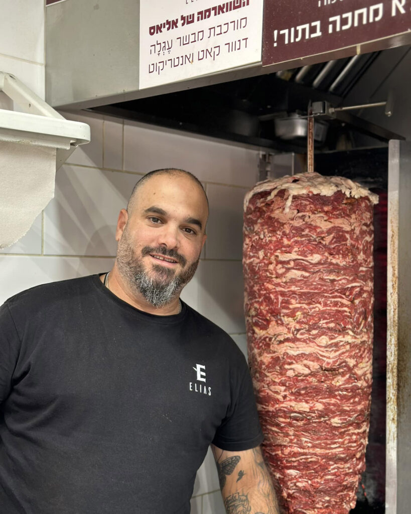 A restaurant owner in Tel Aviv got a giant Doner kebab tattoo inked on his neck, celebrating his love for shawarma. The bold design has sparked mixed reactions online.