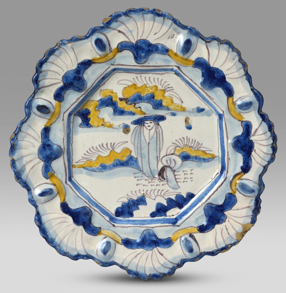 Two rare 17th-century Delftware plates, once carried to Antiques Roadshow in a handbag, have sold for over £20,000 despite one being broken in half.