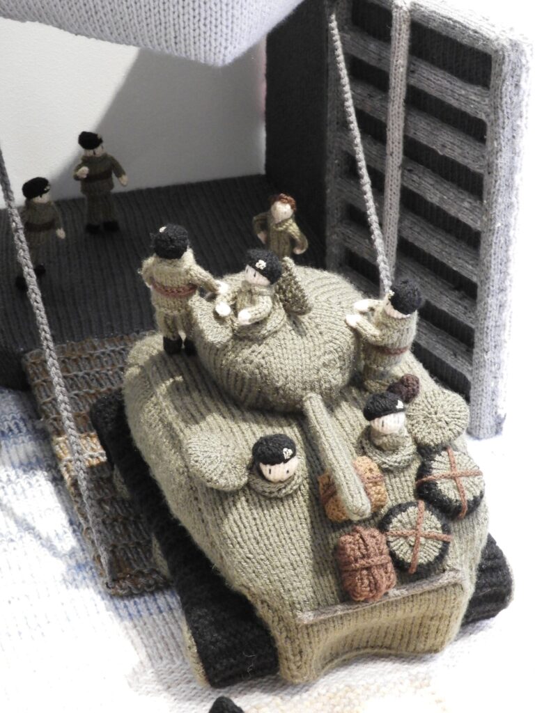 A knitted D-Day exhibition, The Longest Yarn, was canceled in Norwich over safety concerns, but will now be displayed at Peterborough Cathedral in March.