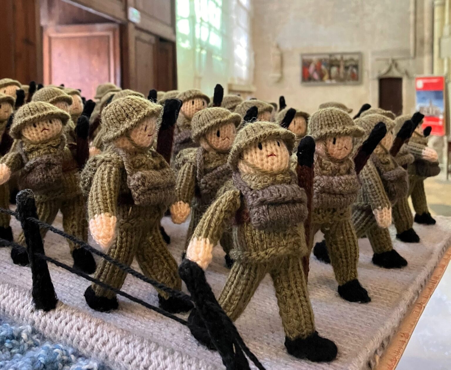 A knitted D-Day exhibition, The Longest Yarn, was canceled in Norwich over safety concerns, but will now be displayed at Peterborough Cathedral in March.