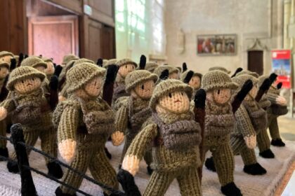 A knitted D-Day exhibition, The Longest Yarn, was canceled in Norwich over safety concerns, but will now be displayed at Peterborough Cathedral in March.