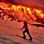 Daredevils ski down Mount Etna as it erupts, gliding past flowing lava in a breathtaking stunt captured by Marco Bassot in Sicily during peak ski season.