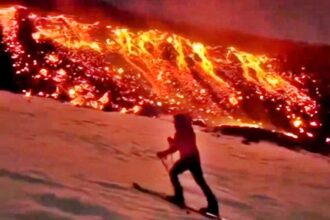 Daredevils ski down Mount Etna as it erupts, gliding past flowing lava in a breathtaking stunt captured by Marco Bassot in Sicily during peak ski season.