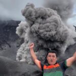 A travel vlogger captured jaw-dropping footage of Mount Dukono erupting up close - as fiery rocks and thick smoke filled the sky in Indonesia.