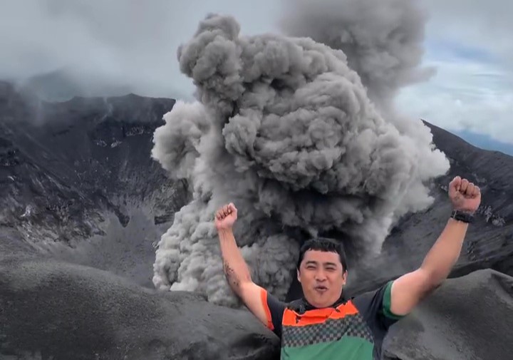 A travel vlogger captured jaw-dropping footage of Mount Dukono erupting up close - as fiery rocks and thick smoke filled the sky in Indonesia.