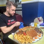 Canadian Joel Hansen shattered Pete Doherty's 2018 mega breakfast record, finishing in just 12 minutes - then ate a second plate in 15 minutes, making history at Margate's Dalby Café.