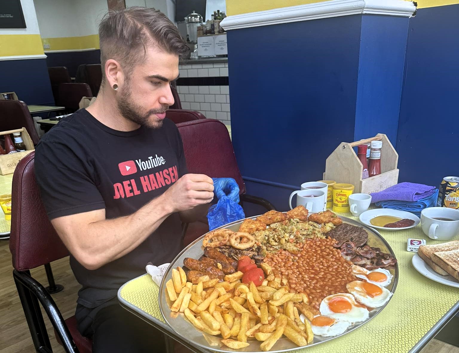 Canadian Joel Hansen shattered Pete Doherty's 2018 mega breakfast record, finishing in just 12 minutes - then ate a second plate in 15 minutes, making history at Margate's Dalby Café.