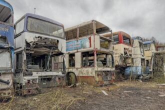 A British explorer uncovers a haunting "bus graveyard" in Yorkshire, filled with decaying double-deckers overtaken by nature in a surreal and eerie discovery.